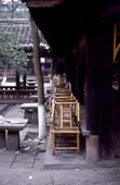 Photographie - Alignement de chaises en bambou d’une maison de thé au sein du monastère